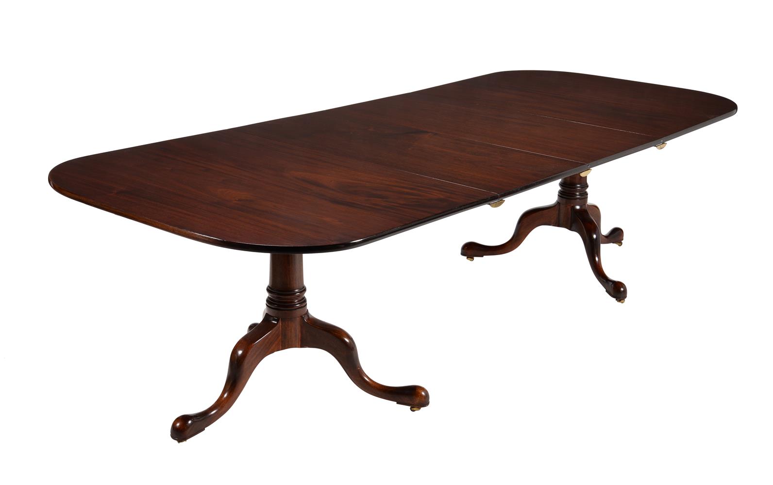 A MAHOGANY TWIN PILLAR DINING TABLE IN GEORGE III STYLE