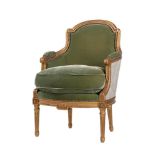 A FRENCH GILTWOOD AND UPHOLSTERED BERGÈRE ARMCHAIR