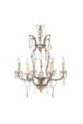 A CLEAR GLASS AND METAL SIX BRANCH CHANDELIER WITH PRISM DROPS