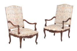 A PAIR OF CARVED WALNUT ARMCHAIRS IN LOUIS XV STYLE