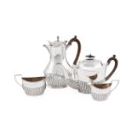 A MATCHED EDWARDIAN SILVER THREE PIECE OVAL HALF REEDED TEA SET