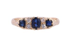 A SAPPHIRE AND DIAMOND SEVEN STONE RING
