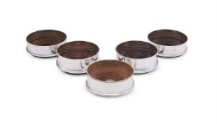 FIVE MODERN SILVER MOUNTED WINE COASTERS