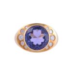 AN 18 CARAT GOLD TANZANITE AND DIAMOND DRESS RING, LONDON 1995