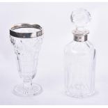 A SILVER MOUNTED CUT GLASS DECANTER, K. M. SILVER