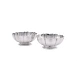 A PAIR OF AMERICAN SILVER COLOURED STANDISH BOWLS