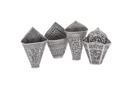 FOUR SILVER COLOURED BETEL LEAF HOLDERS