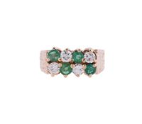 A DIAMOND AND EMERALD EIGHT STONE RING