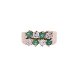 A DIAMOND AND EMERALD EIGHT STONE RING