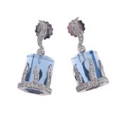 A PAIR OF DIAMOND AND BLUE STONE EARRINGS