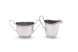 AN AMERICAN SILVER COLOURED OVAL CREAM JUG AND SUGAR BOWL