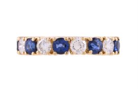 AN 18 CARAT GOLD SAPPHIRE AND DIAMOND HALF BAND RING, LONDON 2001