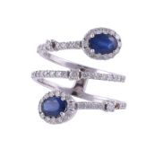 A SAPPHIRE AND DIAMOND CROSSOVER RING