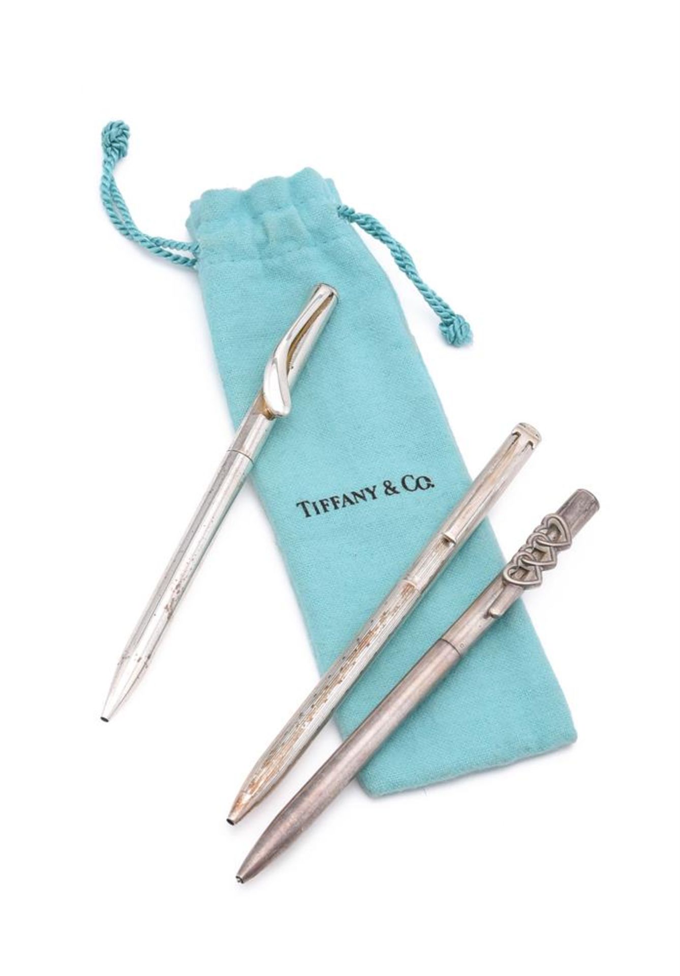 THREE SILVER COLOURED BALL POINT PENS