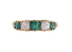 AN EARLY 20TH CENTURY EMERALD AND DIAMOND FIVE STONE RING