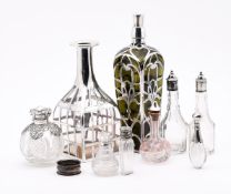 A COLLECTION OF SILVER MOUNTED AND OVERLAID GLASS BOTTLES