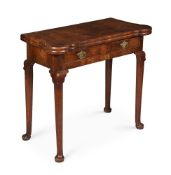 A GEORGE II WALNUT AND FEATHER BANDED FOLDING CARD TABLE, CIRCA 1735