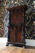 AN ITALIAN CARVED WALNUT STUDIOLO OR WRITING CABINET, 16TH CENTURY