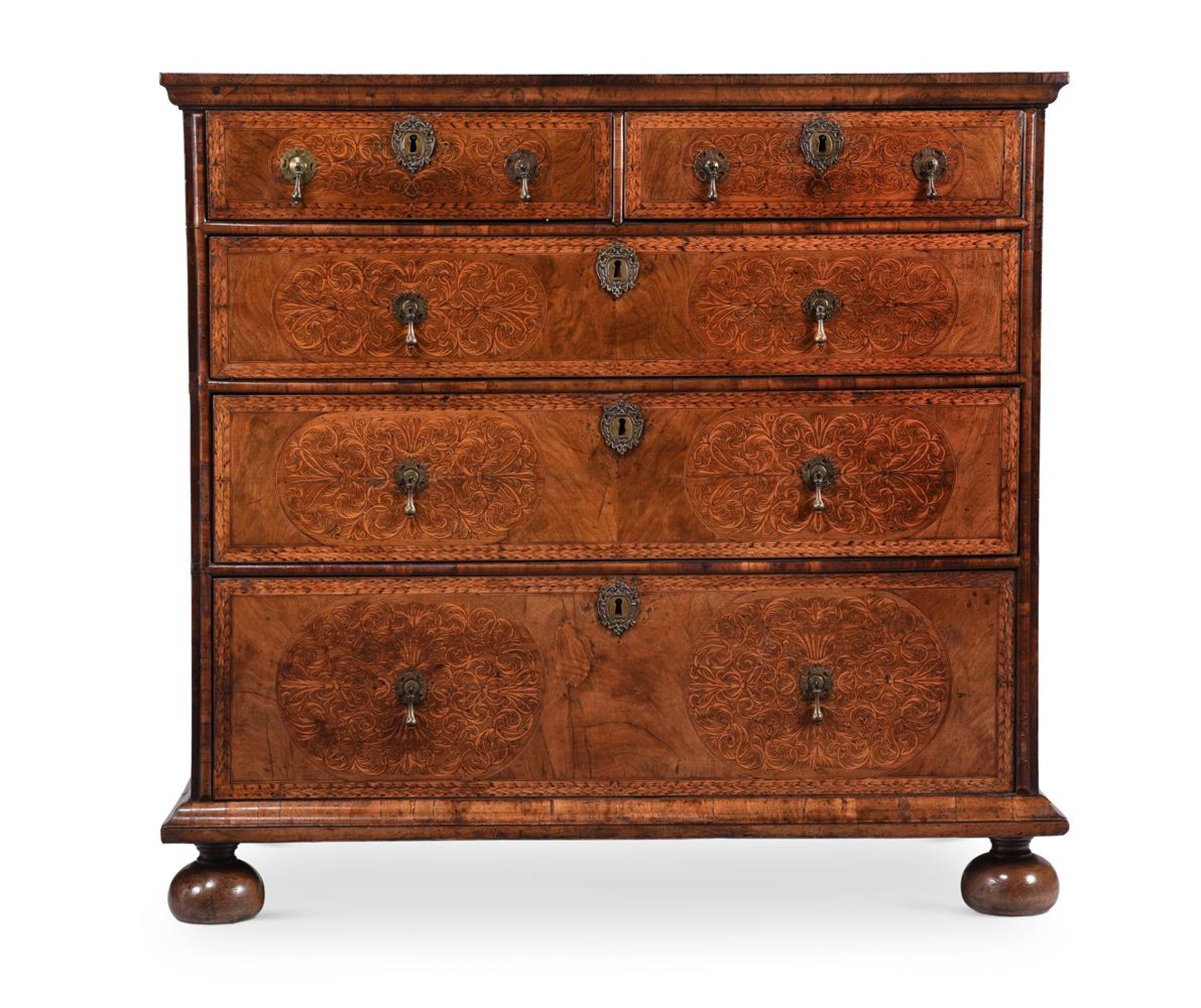 A WILLIAM & MARY WALNUT AND SEAWEED MARQUETRY CHEST OF DRAWERSIN THE MANNER OF GERRIT JENSEN