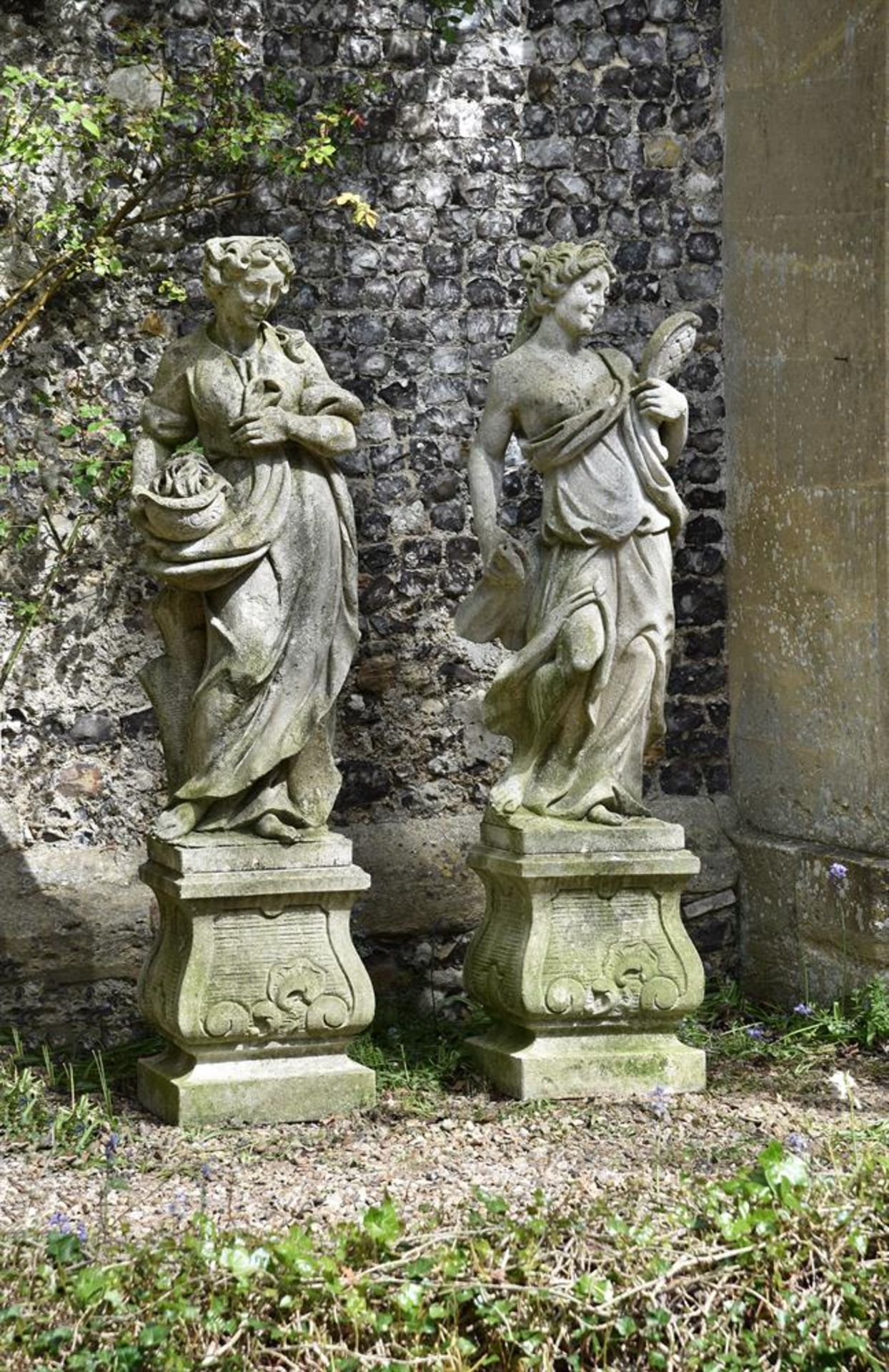 A PAIR OF RECONSTITUTED STONE FEMALE FIGURES EMBLEMATIC OF THE SENSES, LATE 20TH CENTURY