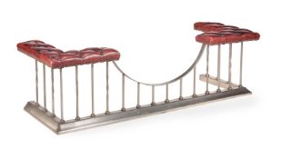 A STEEL AND RED LEATHER UPHOLSTERED CLUB FENDER, 20TH CENTURY