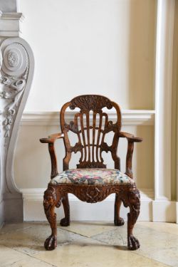 A GEORGE II CARVED WALNUT OPEN ARMCHAIR, ATTRIBUTED TO DANIEL BELL AND THOMAS MOORE, CIRCA 1735