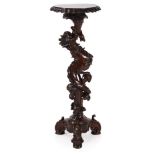 AN ITALIAN CARVED WALNUT TORCHERE STAND, CIRCA 1900