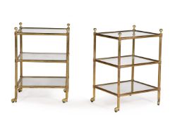 A PAIR OF TUBULAR BRASS AND GLASS THREE TIER TROLLEYS OR ETAGERES, 20TH CENTURY