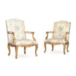 A PAIR OF CARVED GILTWOOD AND PRINTED SILK UPHOLSTERED ARMCHAIRS, IN EARLY 18TH CENTURY STYLE