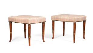 Y A PAIR OF EDWARDIAN SATINWOOD, PAINTED AND PARCEL GILT STOOLS IN REGENCY STYLE, CIRCA 1905
