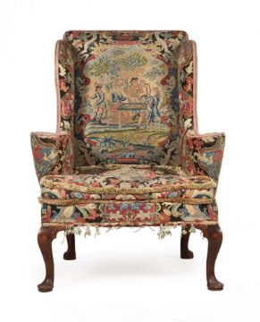 AN EARLY GEORGE II WALNUT AND NEEDLEWORK UPHOLSTERED WING ARMCHAIR, CIRCA 1730