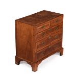 A GEORGE II BURR AND FIGURED WALNUT CHEST OF DRAWERS, CIRCA 1730