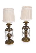 A PAIR OF GILT BRASS CANDLESTICKS, 19TH CENTURY AND LATER FITTED AS LAMPS