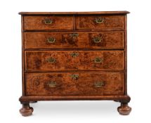 A QUEEN ANNE MULBERRY AND FEATHER BANDED CHEST OF DRAWERS, CIRCA 1710