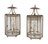 A PAIR OF GLAZED, BRASS FRAMED AND MIRROR BACKED WALL LANTERNS, 20TH CENTURY