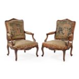 A PAIR OF FRENCH WALNUT AND NEEDLEWORK UPHOLSTERED FAUTEUILS, IN REGENCE STYLE, 19TH CENTURY