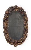 A CARVED WALNUT AND PARCEL GILT WALL MIRROR, EARLY 18TH CENTURY AND LATER