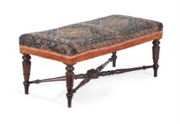 AN EARLY VICTORIAN MAHOGANY AND CARPET UPHOLSTERED STOOL