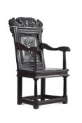 A VICTORIAN CARVED AND STAINED OAK WAINSCOT ARMCHAIR