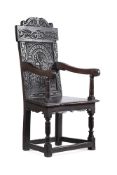 A VICTORIAN CARVED OAK ARMCHAIR IN 17TH CENTURY STYLE
