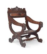 A CARVED WLANUT LOW ARMCHAIR