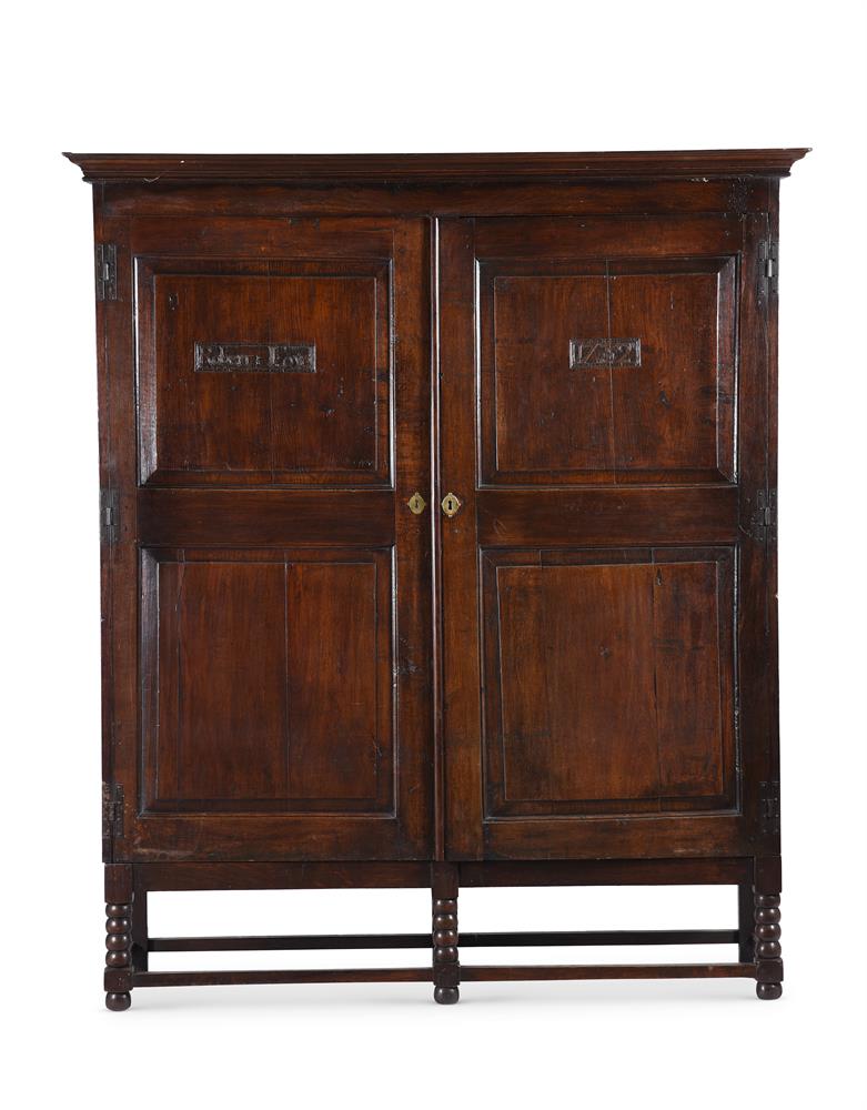 A LARGE OAK WARDROBE IN EARLY 18TH CENTURY STYLE