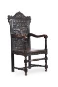 A VICTORIAN CARVED AND STAINED OAK ARMCHAIR IN 17TH CENTURY STYLE