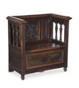 A CARVED OAK HALL SEAT IN ANTIQUARIAN TASTE
