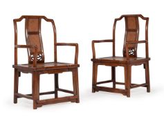 A pair of Chinese elm yoke back armchairs