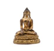 A Tibetan style gilt bronze figure of Buddha