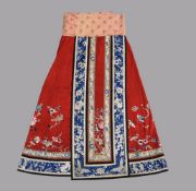 A Chinese red silk damask skirt with tight pleating