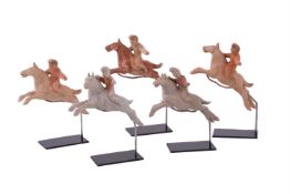 A rare set of five miniature pottery polo players