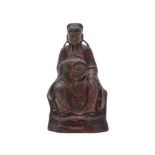 A Chinese lacquered bronze model of a seated scholar