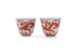 A pair of iron-red 'Dragon' wine cups